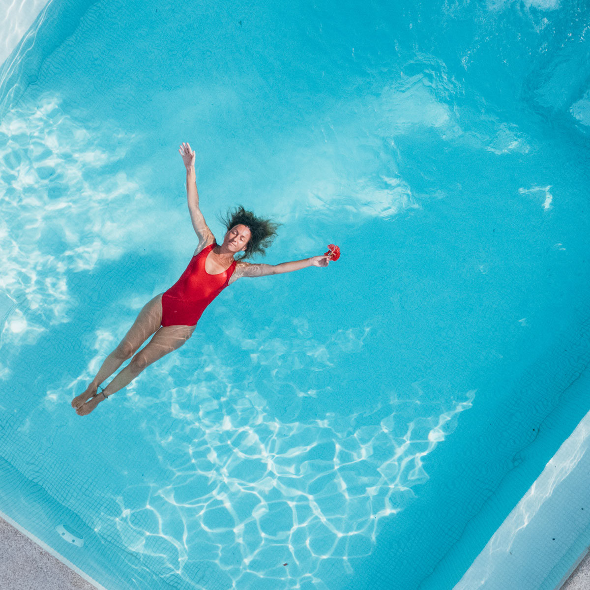 lady laying in luxury pool